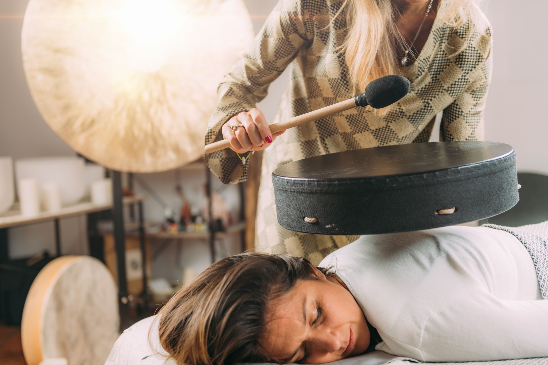 Playing Moon Drum in Sound Healing Therapy Session