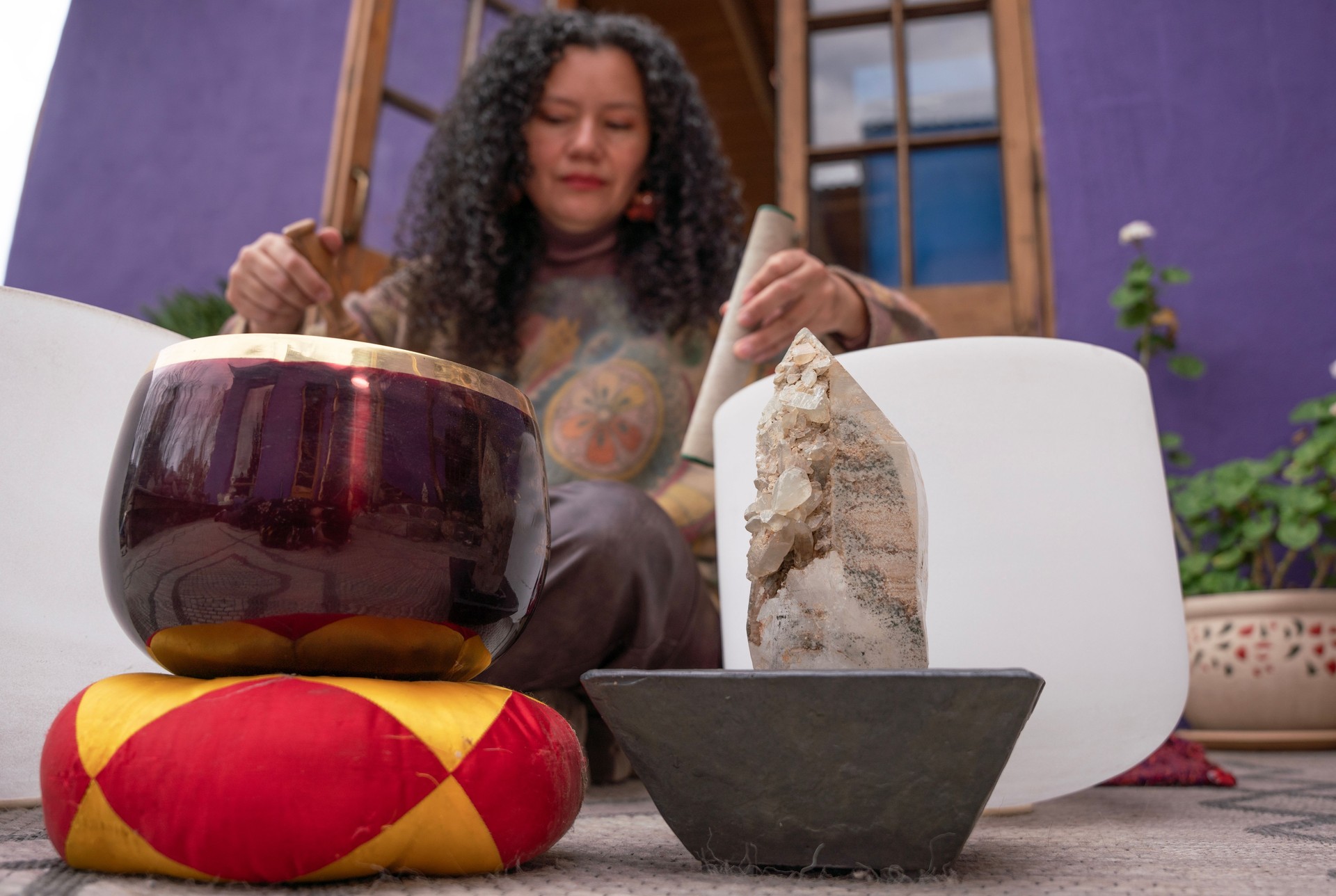 Woman playing singing bowls for sound healing